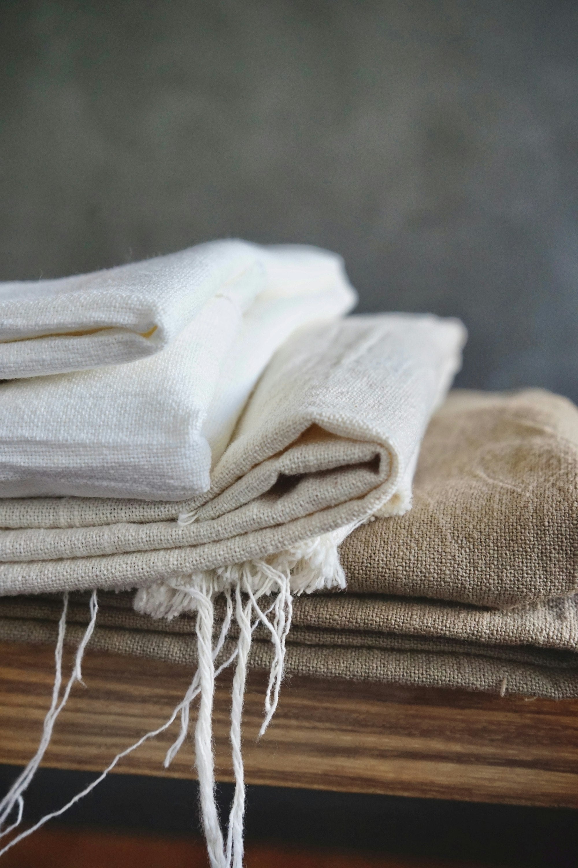 White fabric draped over wood — comparing Tencel and linen
